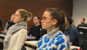 Group of students sitting in lecture hall.